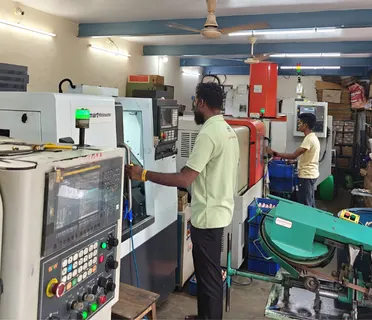 Operators at CNC machines on the Swami Engineering shop floor